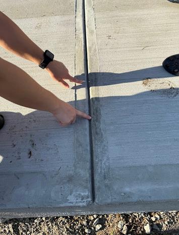 A concrete contractor pointing at the surface