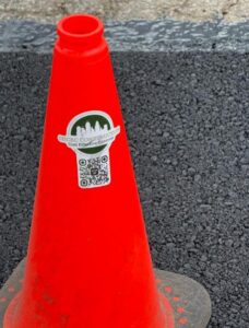 A triangle cone in the newly laid-out concrete driveway.