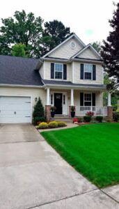 Concrete driveway leading to a modern residential home exterior