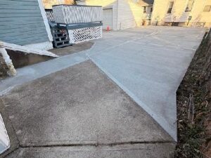 A concrete walkway connected with the driveway.