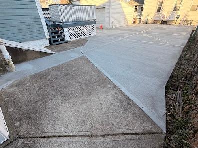 A concrete walkway connected with the driveway.