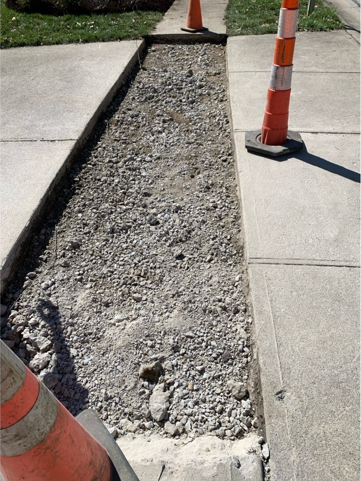 Concrete surface over prepared ground as part of a drainage and concrete project